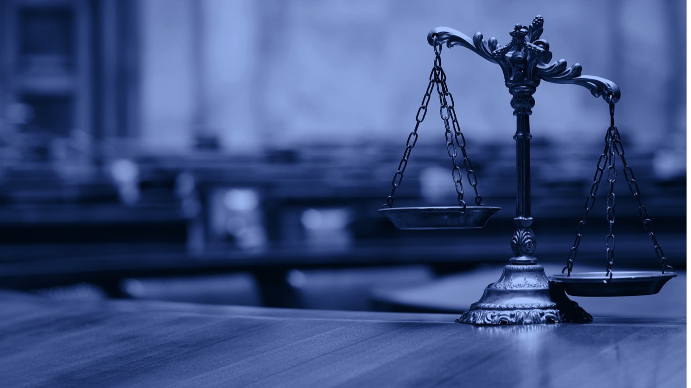 Scales of justice on a courtroom desk